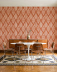 Reed & Smoke Terracotta geometric wallpaper in a mid-century dining room with a teak sideboard and tulip table