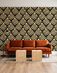Rising Arrow Noir geometric wallpaper behind a rust velvet sofa in a bright coworking lounge
