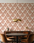 Rising Arrow Terracotta geometric wallpaper behind a walnut credenza and round table in an elegant dining room
