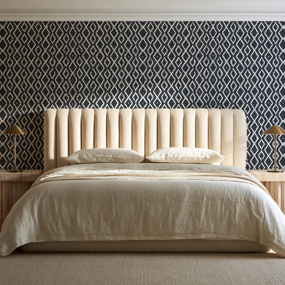Sage Trellis Charcoal geometric wallpaper behind a channel-tufted bed in a calm primary bedroom