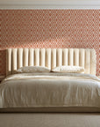 Sage Trellis Terracotta geometric wallpaper behind a channel-tufted bed in a calm primary bedroom
