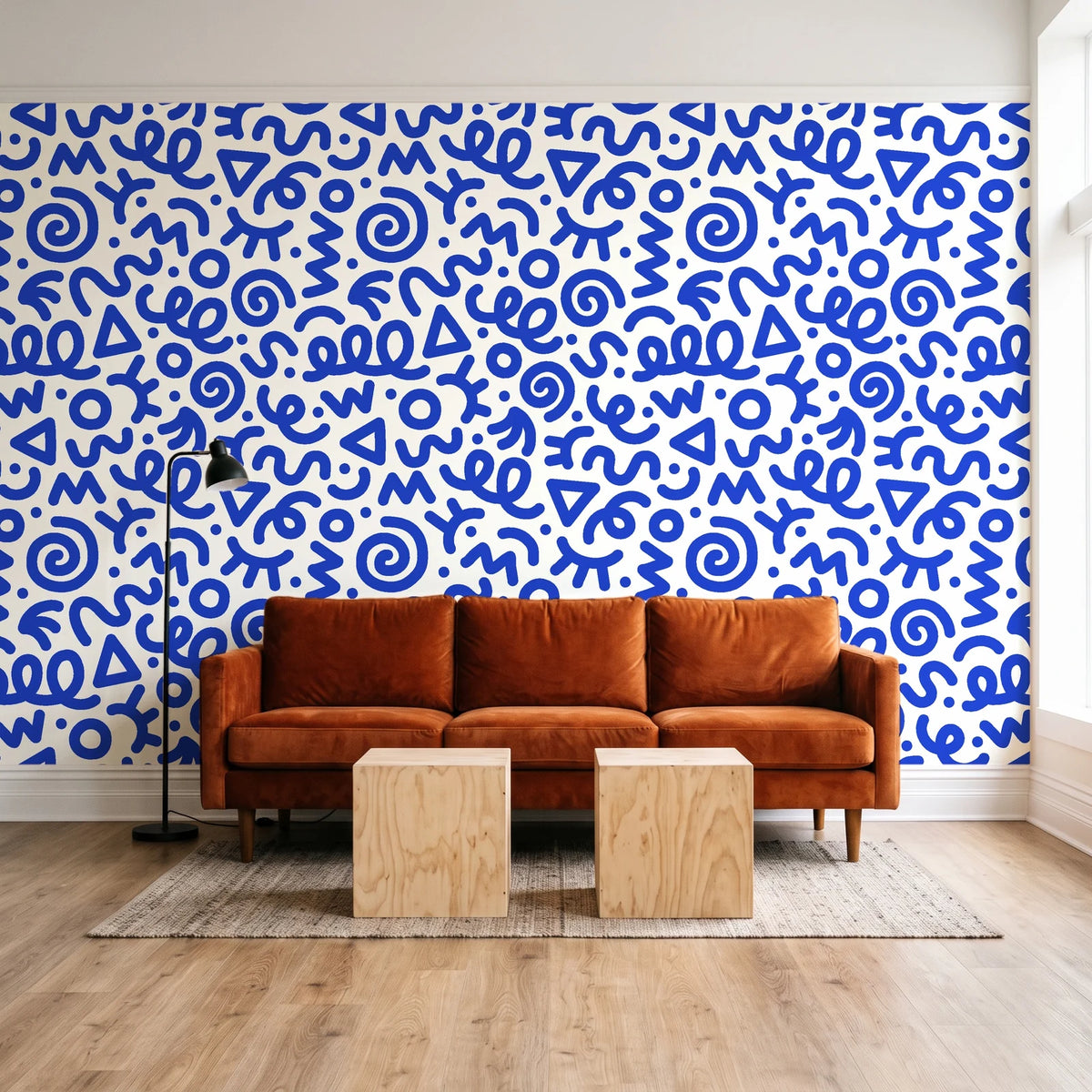 Scribble Pop Cobalt squiggle wallpaper behind a rust velvet sofa in a bright coworking lounge