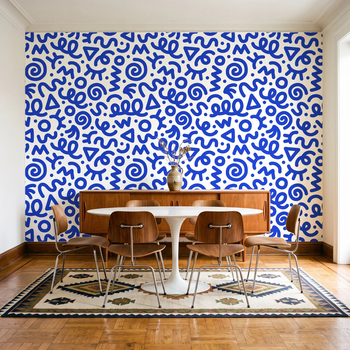 Scribble Pop Cobalt squiggle wallpaper in a mid-century dining room with a teak sideboard and tulip table
