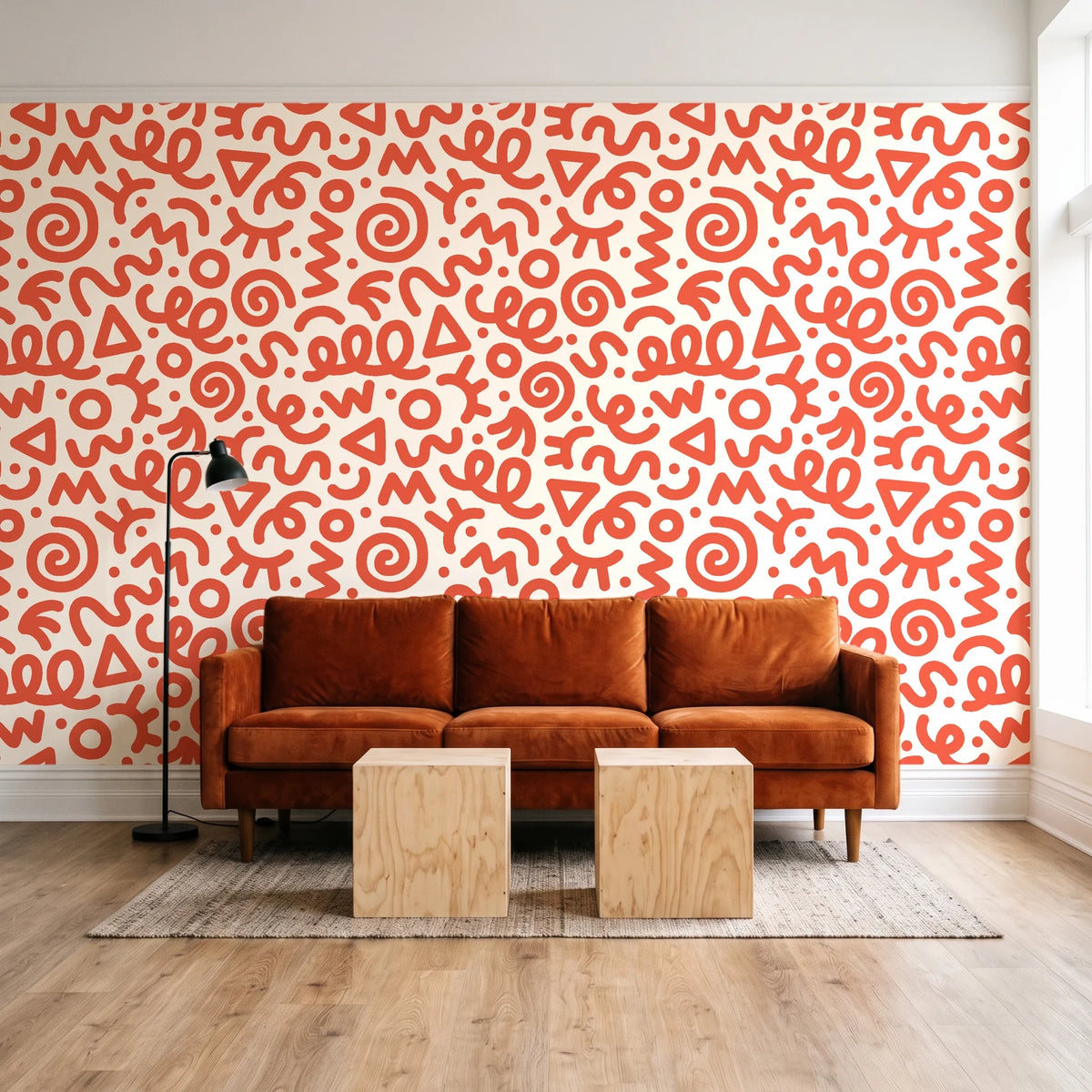 Scribble Pop Coral squiggle wallpaper behind a rust velvet sofa in a bright coworking lounge