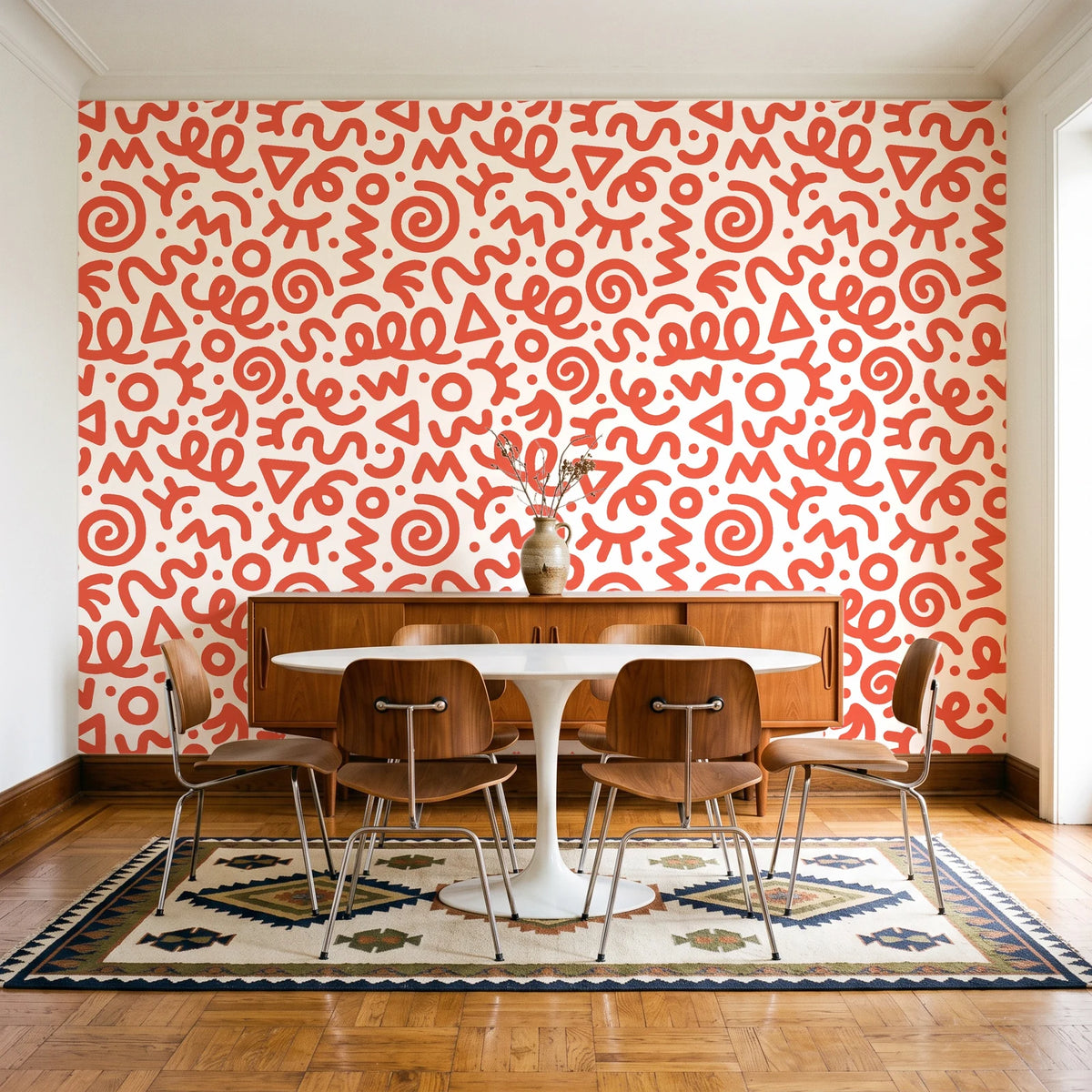 Scribble Pop Coral squiggle wallpaper in a mid-century dining room with a teak sideboard and tulip table