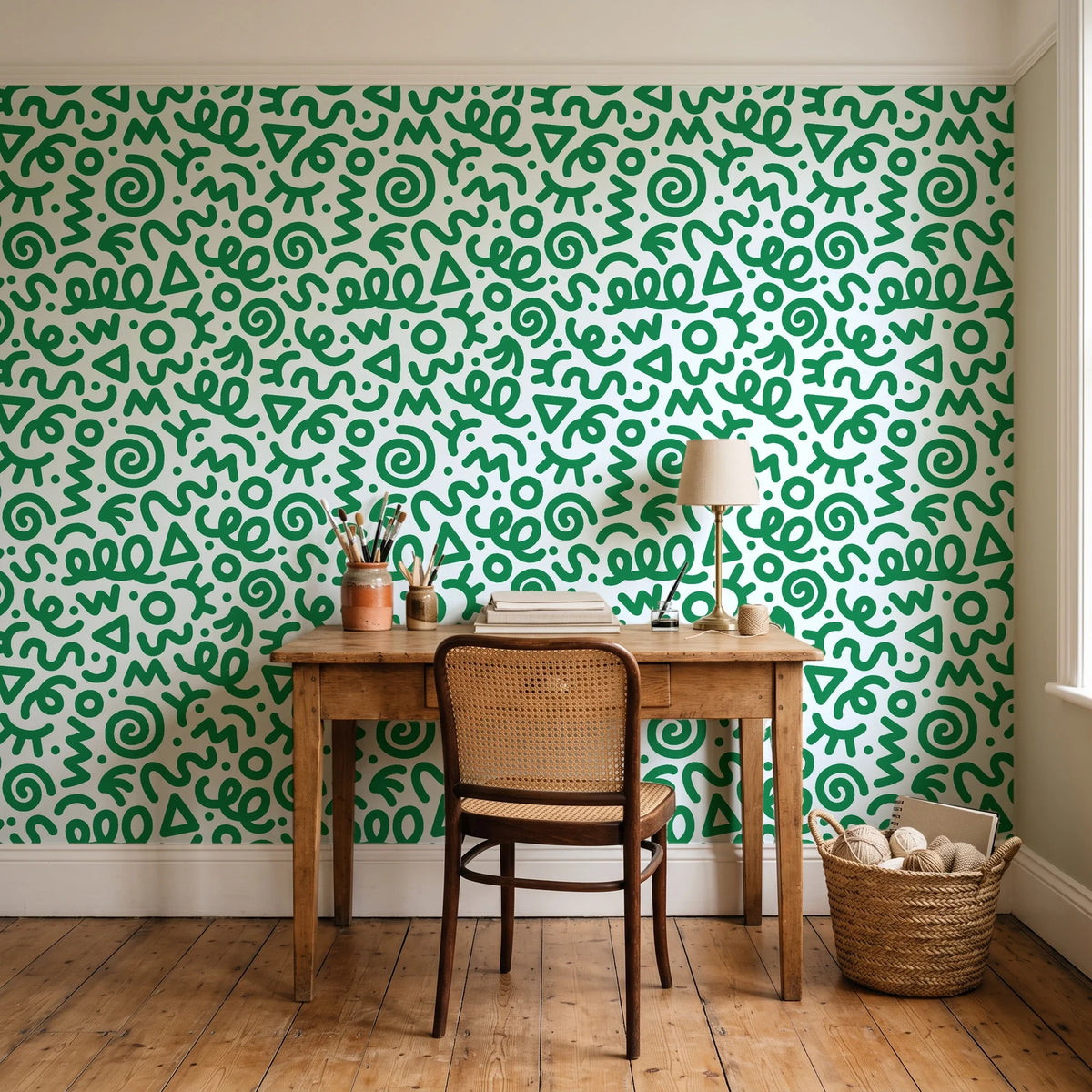 Scribble Pop Kelly Green squiggle wallpaper behind a vintage writing desk in a cozy craft-room home office