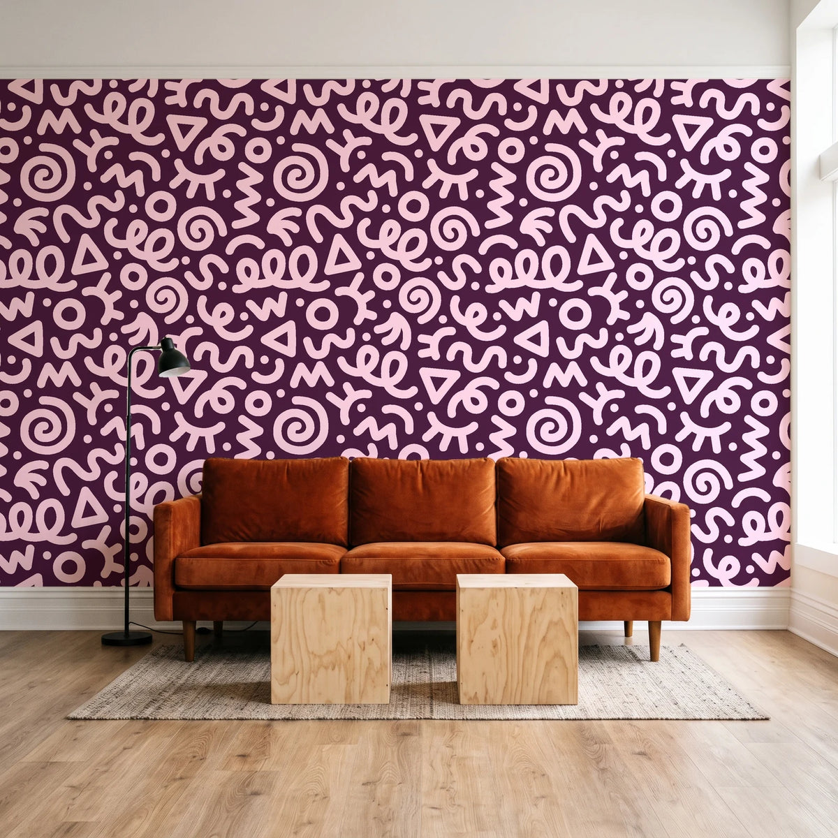 Scribble Pop Mulberry squiggle wallpaper behind a rust velvet sofa in a bright coworking lounge
