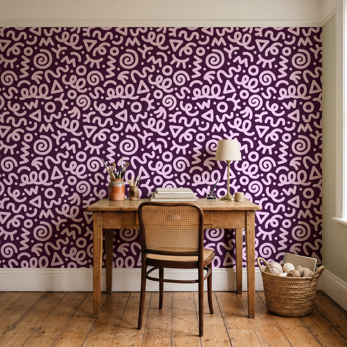 Scribble Pop Mulberry squiggle wallpaper behind a vintage writing desk in a cozy craft-room home office