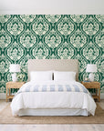 Secret Arbor Emerald damask wallpaper behind a queen bed in a bright coastal bedroom