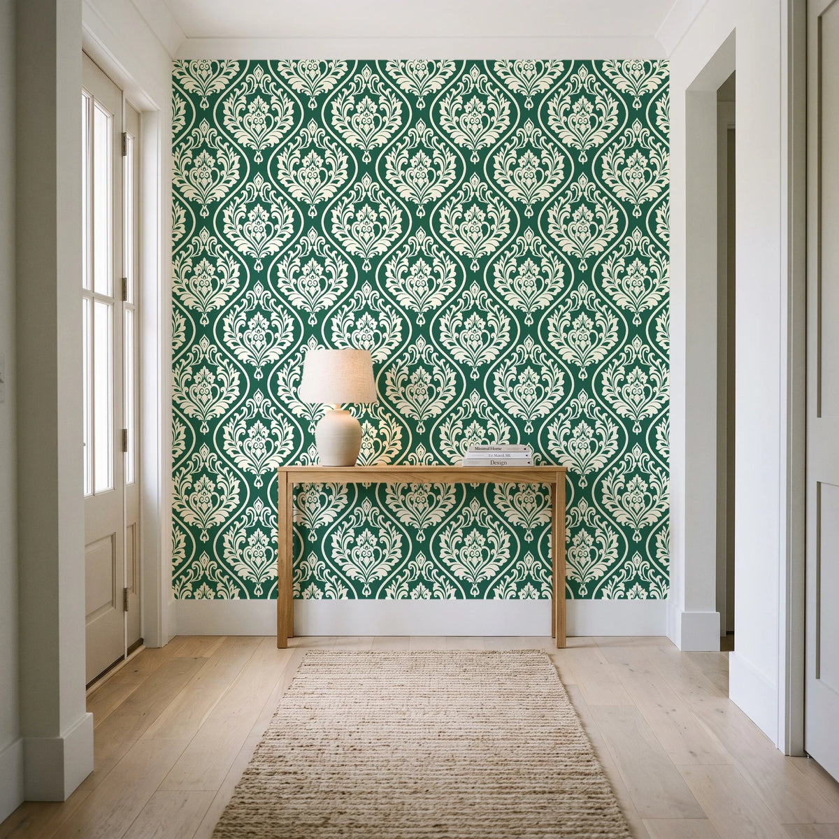 Secret Arbor Emerald damask wallpaper behind a console table in a light entry hallway