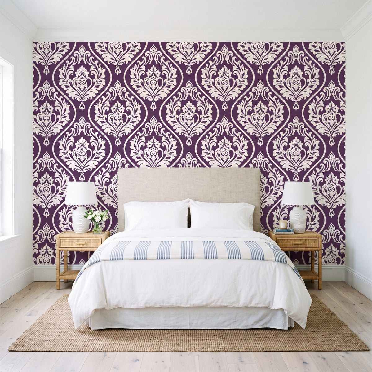 Secret Arbor Plum damask wallpaper behind a queen bed in a bright coastal bedroom