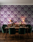 Secret Arbor Plum damask wallpaper in a dark moody dining room with a candlelit table