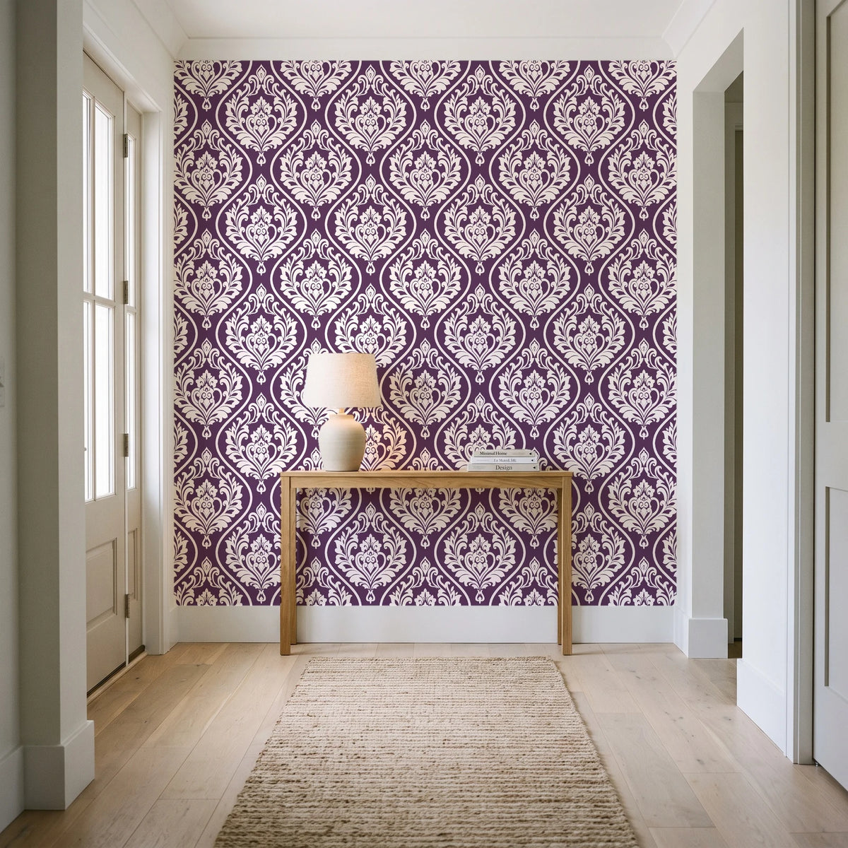 Secret Arbor Plum damask wallpaper behind a console table in a light entry hallway