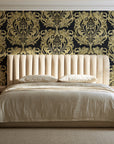 Serene Blossom Noir damask wallpaper behind a channel-tufted bed in a calm primary bedroom