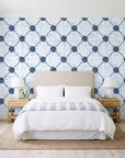 Shadow Garden Navy lattice floral wallpaper behind a queen bed in a bright coastal bedroom