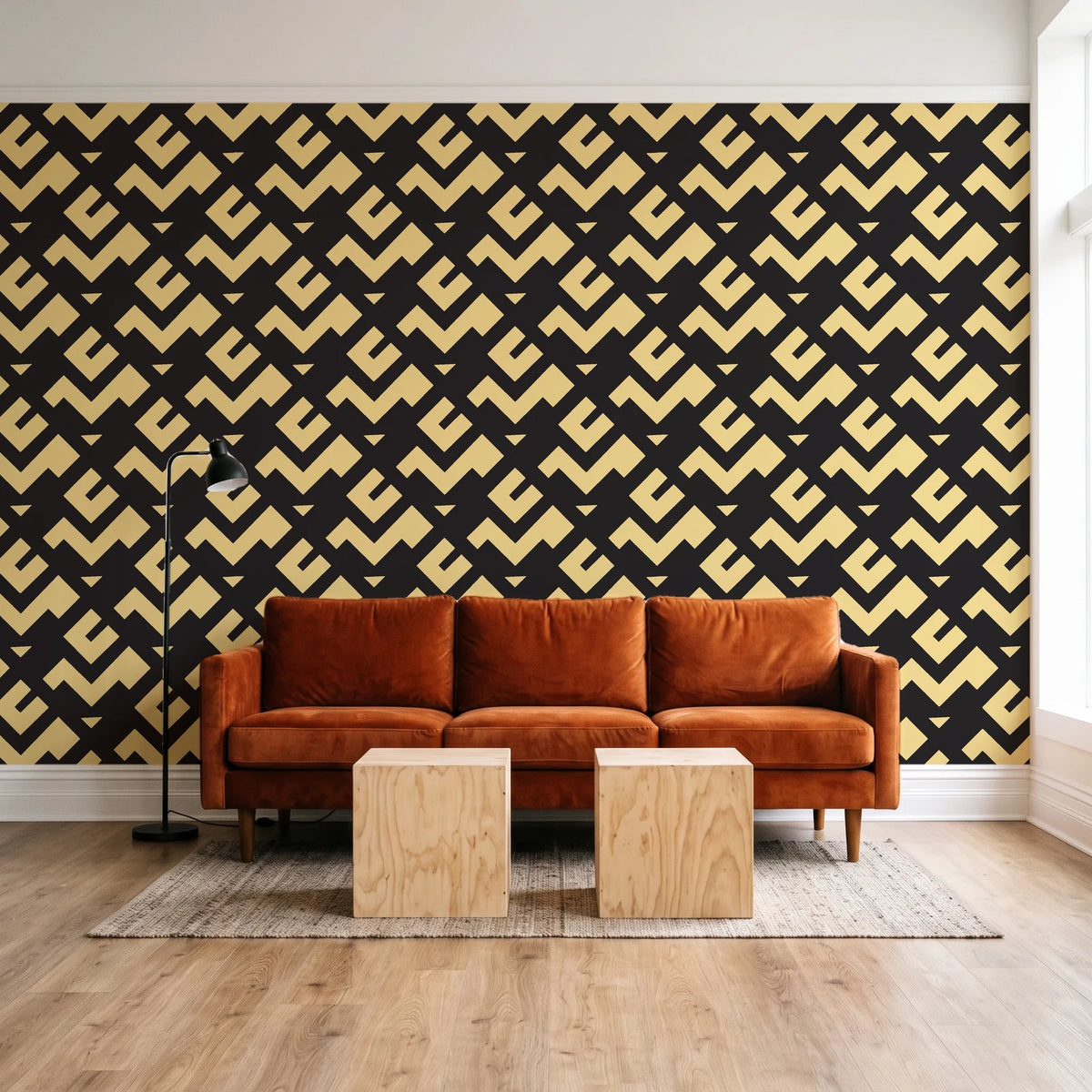 Signal & Edge Noir geometric wallpaper behind a rust velvet sofa in a bright coworking lounge