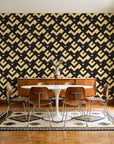 Signal & Edge Noir geometric wallpaper in a mid-century dining room with a teak sideboard and tulip table