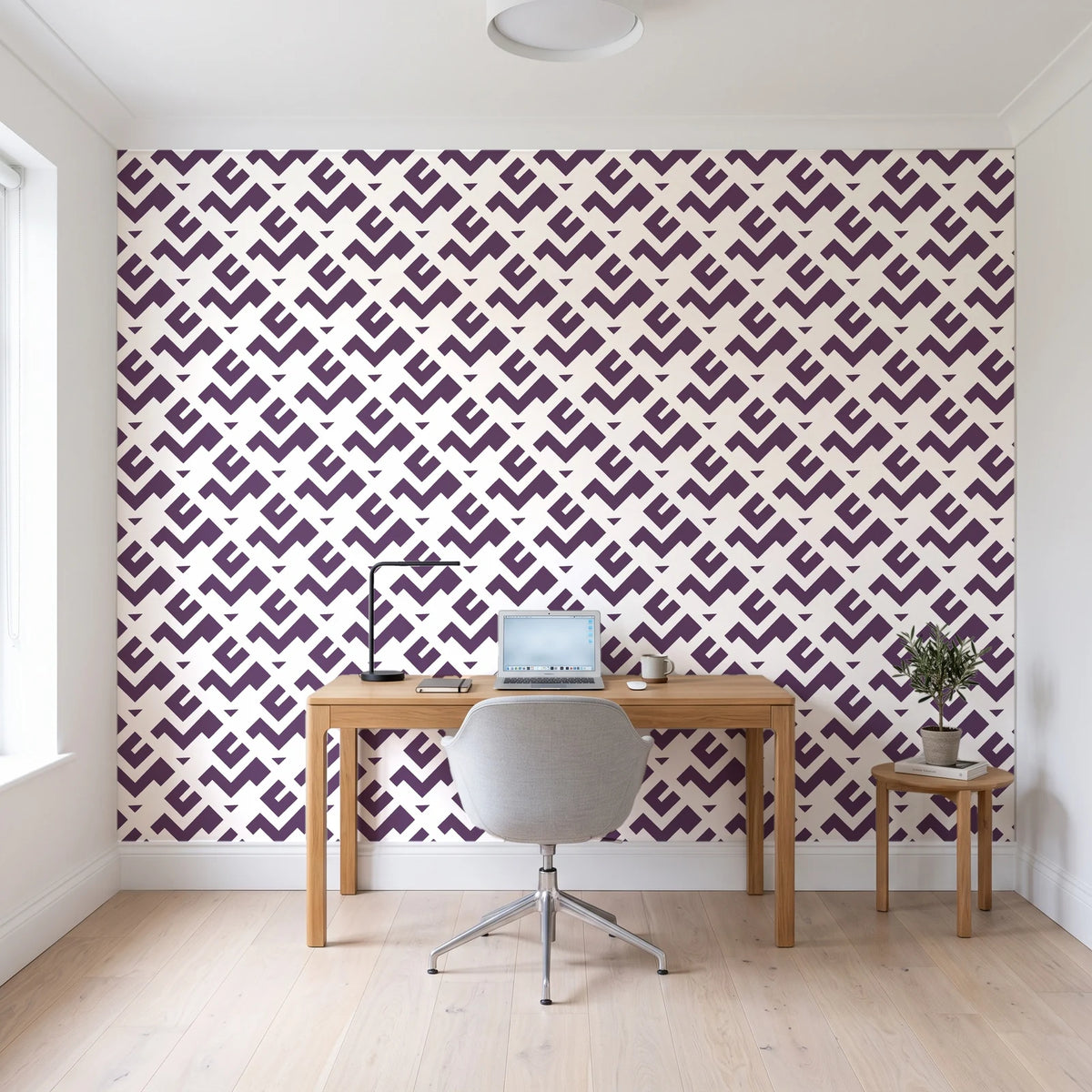 Signal & Edge Plum geometric wallpaper behind a modern oak desk in a bright home office