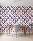 Signal & Edge Plum geometric wallpaper behind a modern oak desk in a bright home office