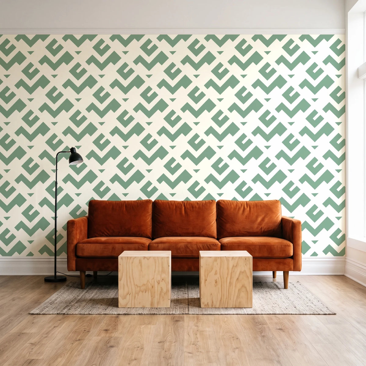 Signal & Edge Sage geometric wallpaper behind a rust velvet sofa in a bright coworking lounge