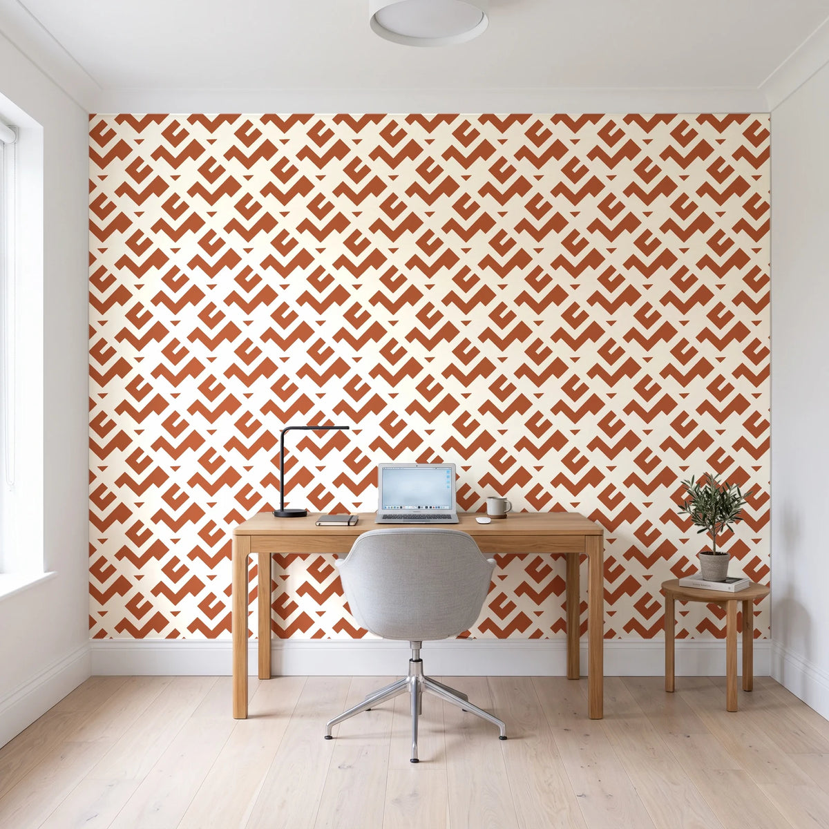 Signal & Edge Terracotta geometric wallpaper behind a modern oak desk in a bright home office