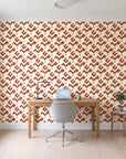 Signal & Edge Terracotta geometric wallpaper behind a modern oak desk in a bright home office