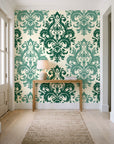 Silent Bouquet Emerald damask wallpaper behind a console table in a light entry hallway