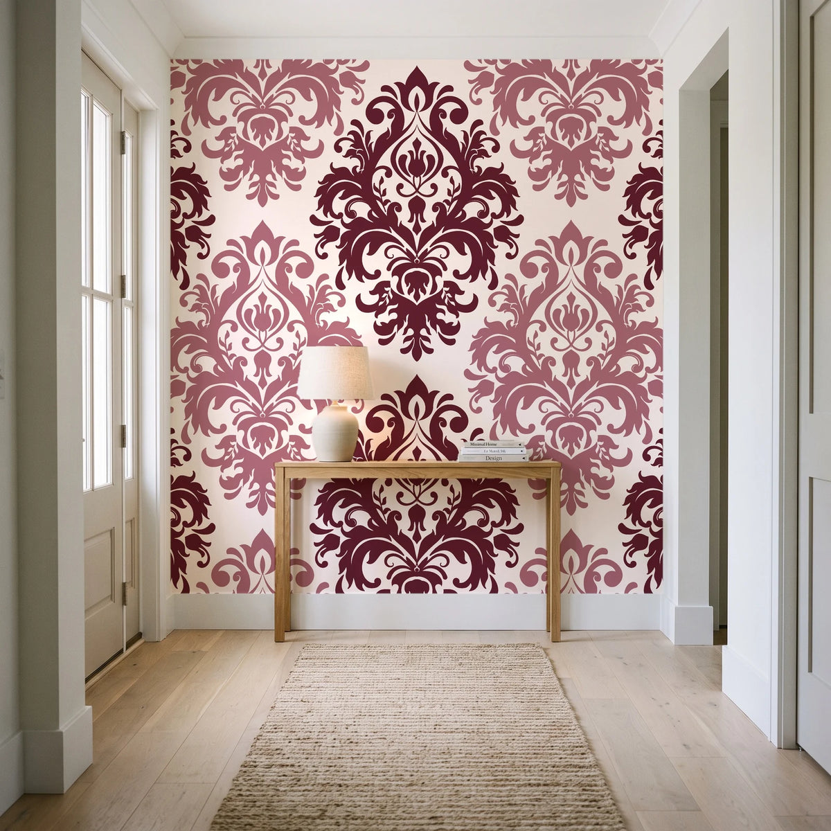 Silent Bouquet Oxblood damask wallpaper behind a console table in a light entry hallway