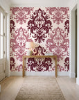 Silent Bouquet Oxblood damask wallpaper behind a console table in a light entry hallway