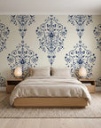 Silent Spring Navy damask wallpaper behind a low platform bed in a serene Japandi bedroom