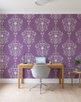 Silent Spring Plum damask wallpaper behind a modern oak desk in a bright home office