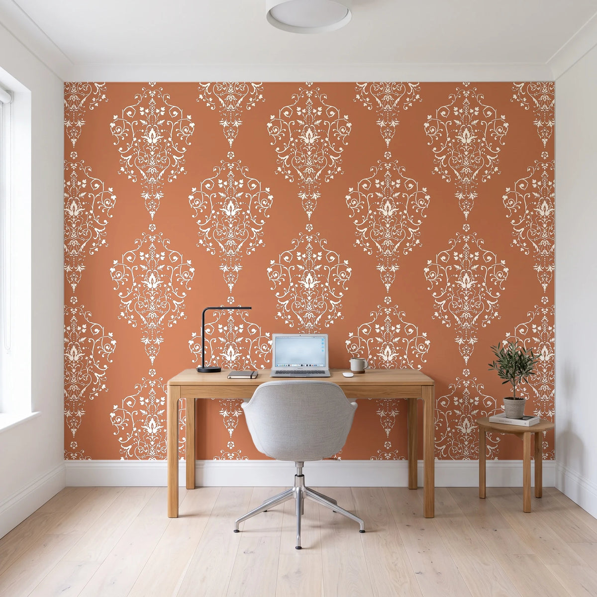 Silent Spring Terracotta damask wallpaper behind a modern oak desk in a bright home office