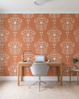 Silent Spring Terracotta damask wallpaper behind a modern oak desk in a bright home office