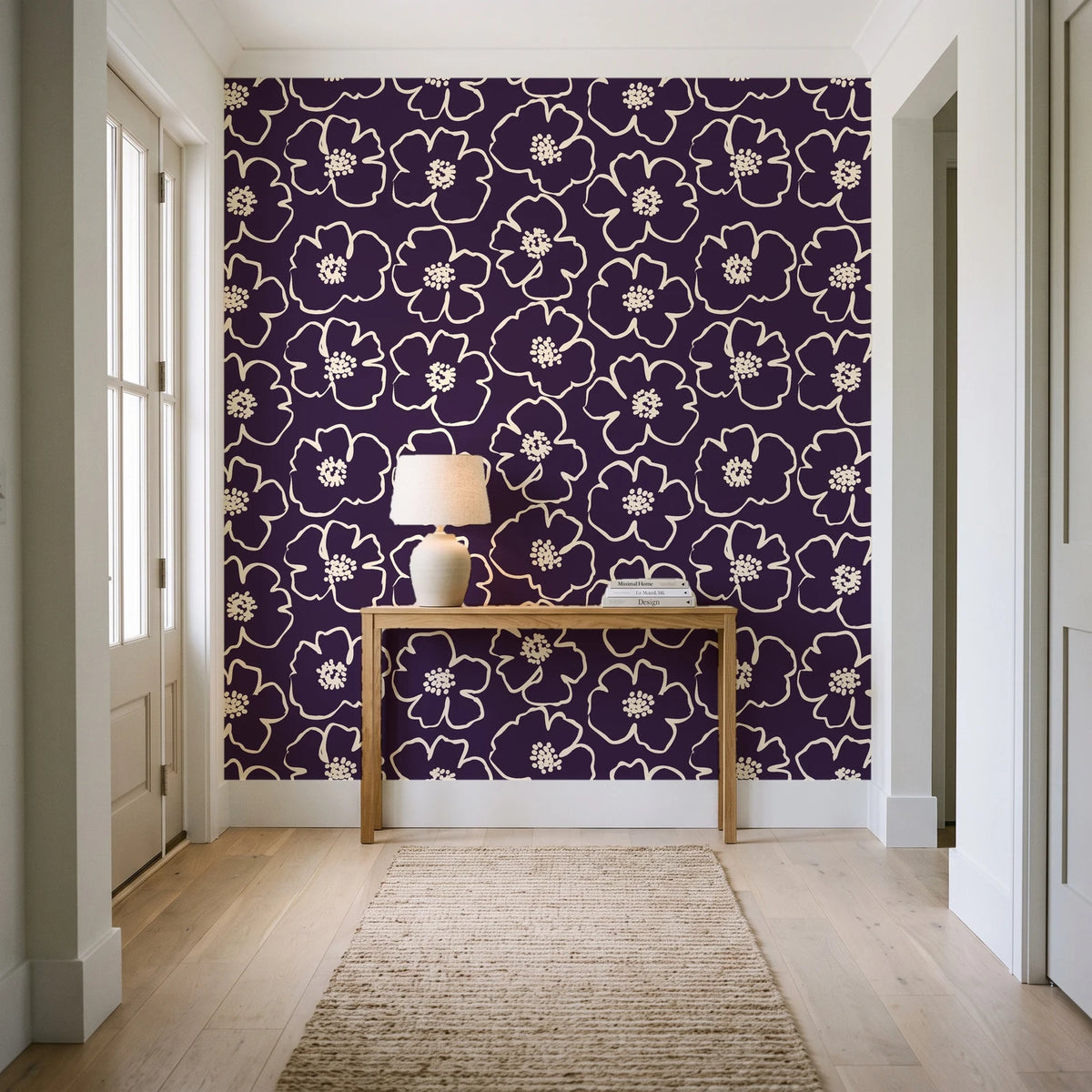 Sketch Anemone Aubergine sketched anemone wallpaper behind a console table in a light entry hallway