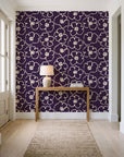 Sketch Anemone Aubergine sketched anemone wallpaper behind a console table in a light entry hallway