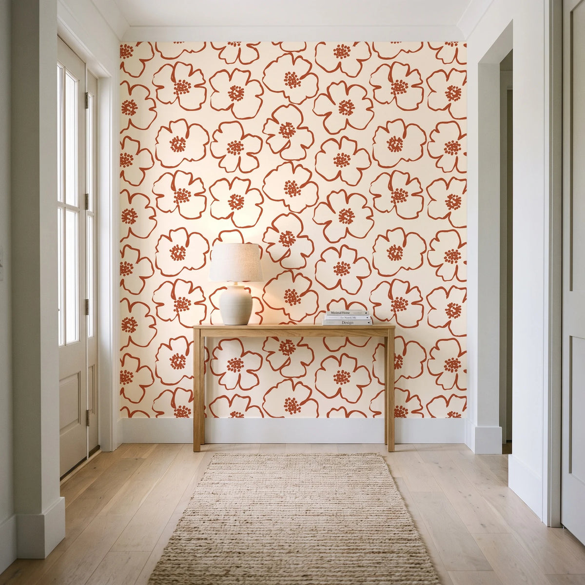 Sketch Anemone Terracotta sketched anemone wallpaper behind a console table in a light entry hallway