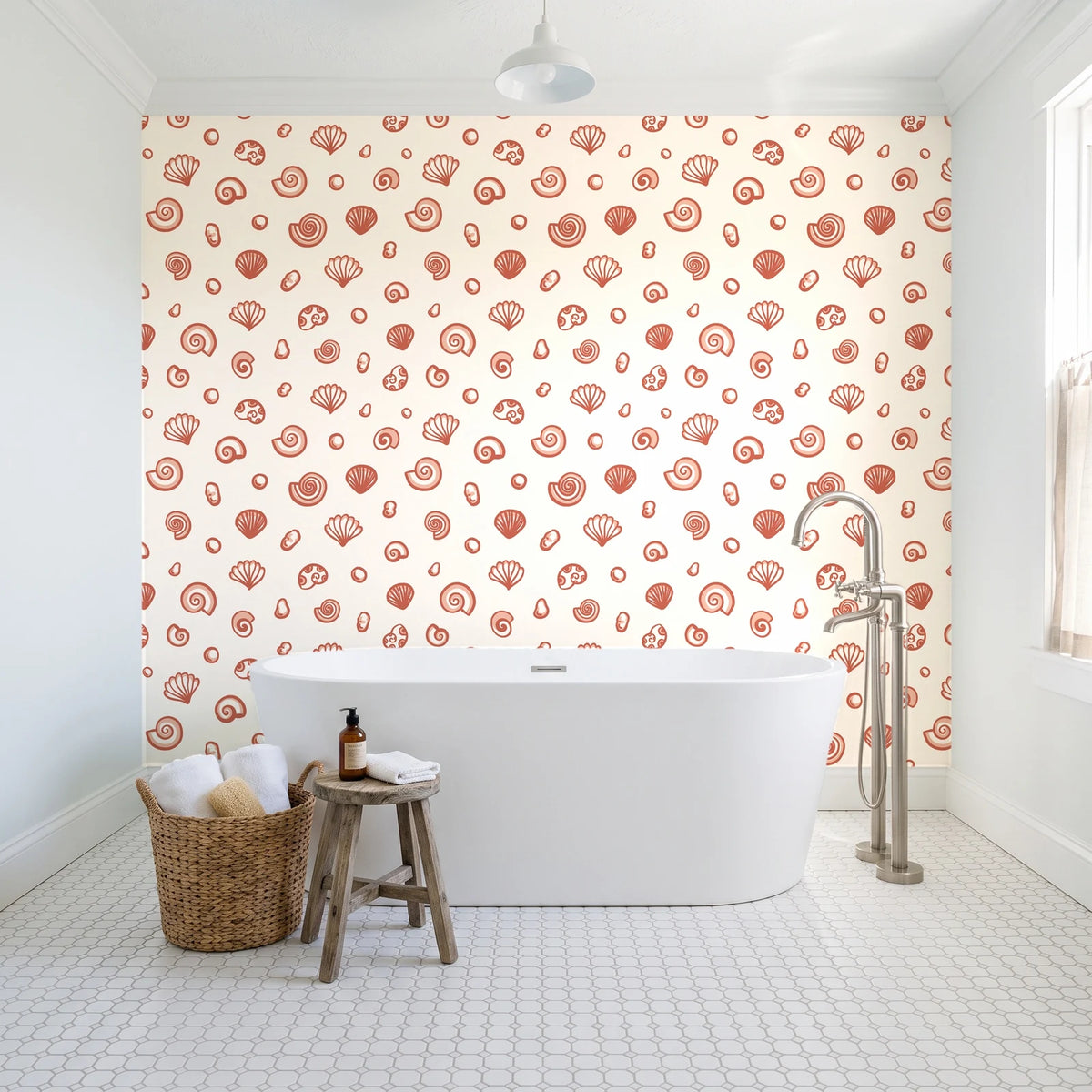Sketched Seashells Coral seashell wallpaper behind a freestanding tub in a bright coastal bathroom