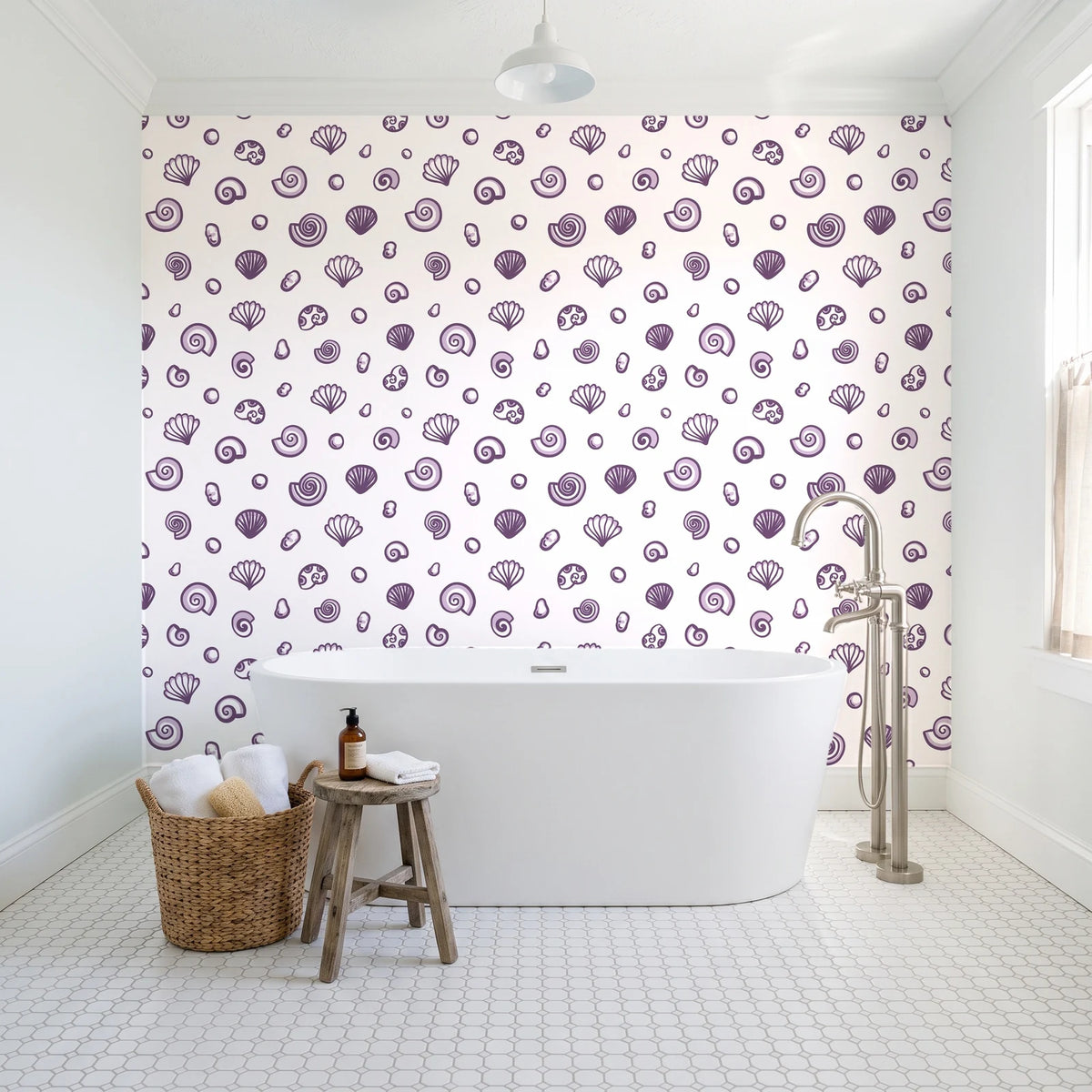 Sketched Seashells Plum seashell wallpaper behind a freestanding tub in a bright coastal bathroom