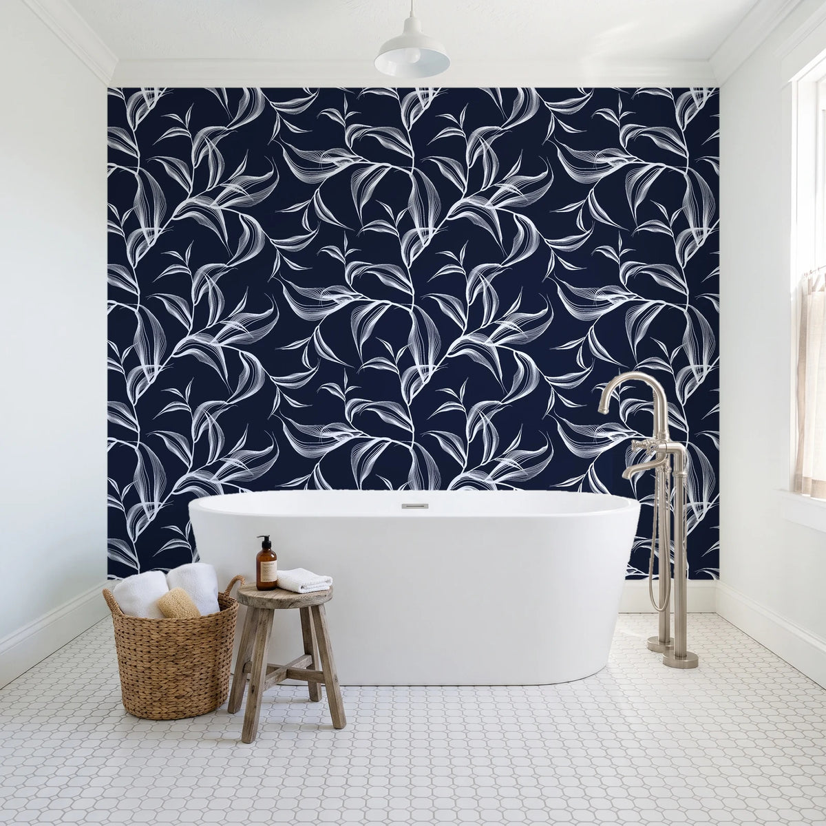 Sketched Silence Midnight line art leaf wallpaper behind a freestanding tub in a bright coastal bathroom