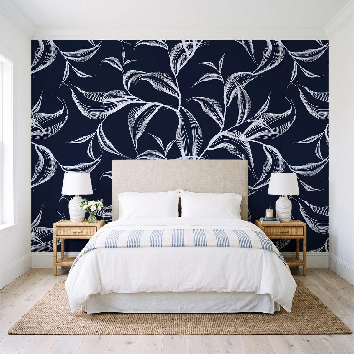 Sketched Silence Midnight line art leaf wallpaper behind a queen bed in a bright coastal bedroom