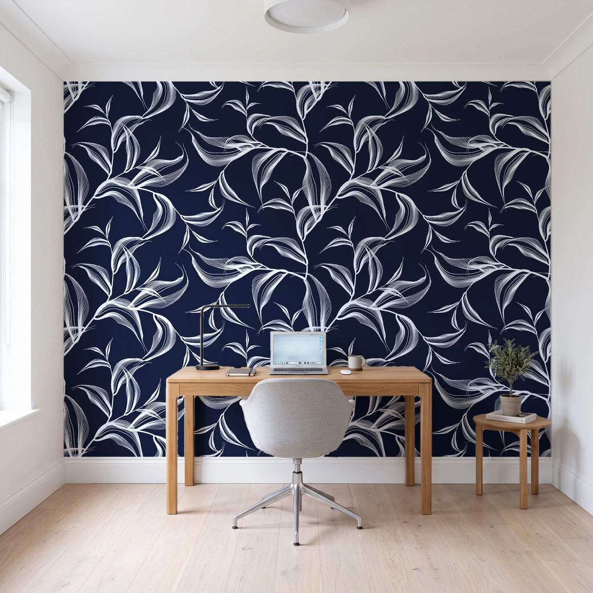 Sketched Silence Midnight line art leaf wallpaper behind a modern oak desk in a bright home office