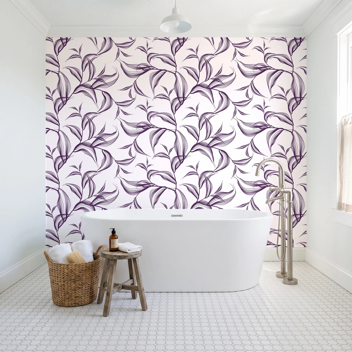 Sketched Silence Plum line art leaf wallpaper behind a freestanding tub in a bright coastal bathroom