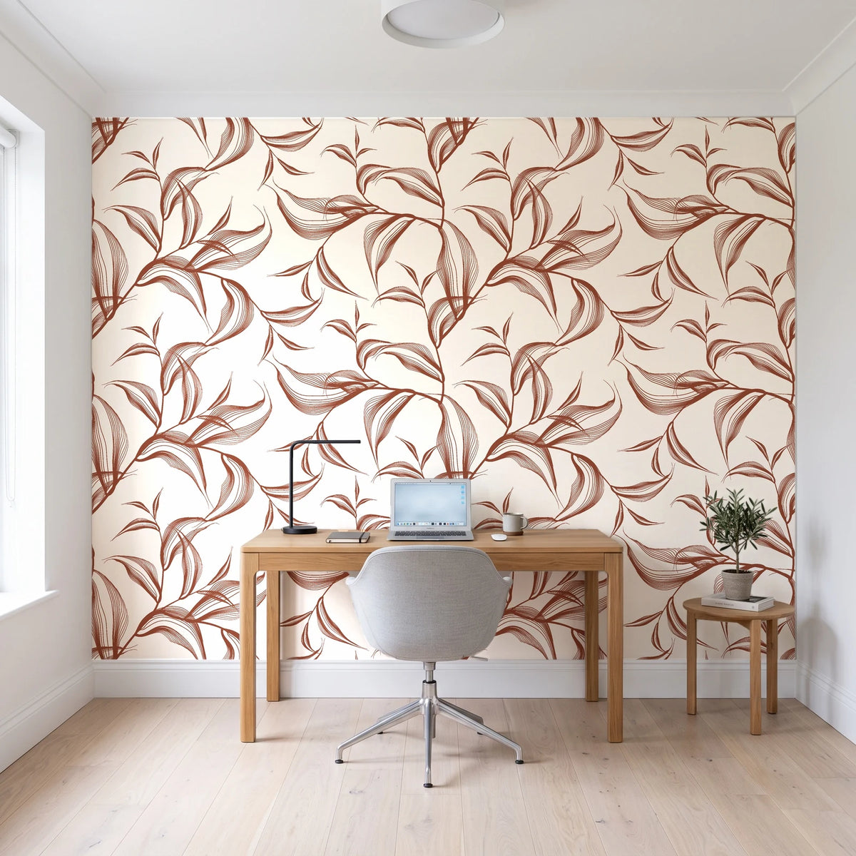 Sketched Silence Rust line art leaf wallpaper behind a modern oak desk in a bright home office