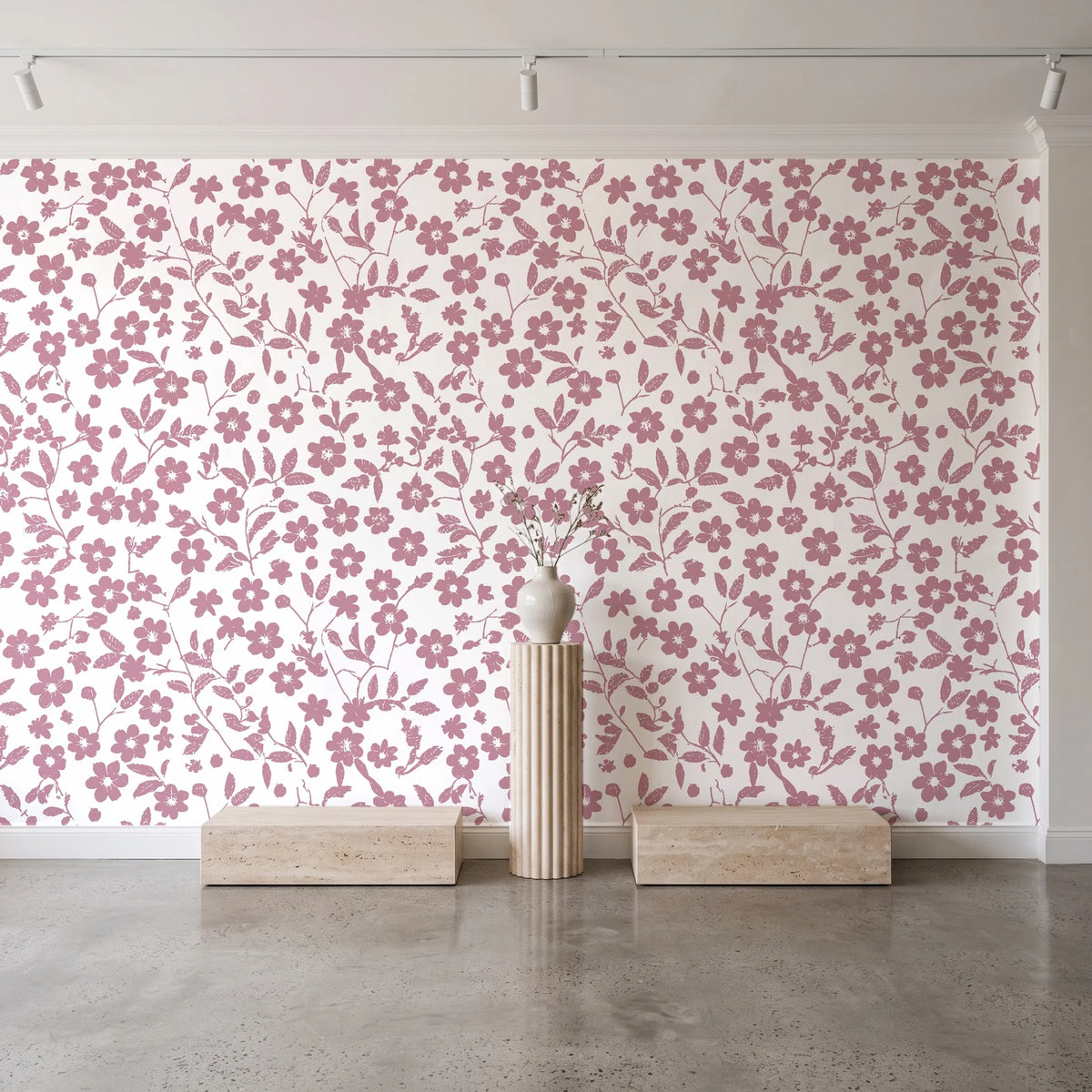 Sky Bloom Rose floral wallpaper behind a travertine pedestal and vase in a minimal boutique