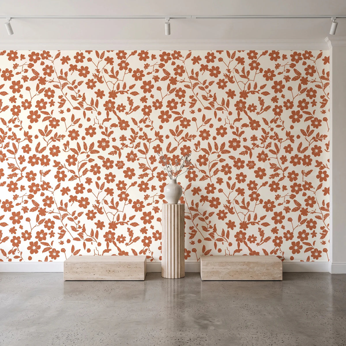 Sky Bloom Terracotta floral wallpaper behind a travertine pedestal and vase in a minimal boutique