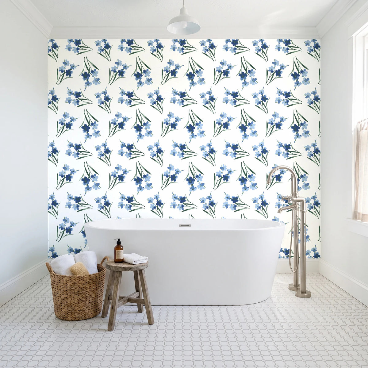 Sky Memory Midnight watercolor floral wallpaper behind a freestanding tub in a bright coastal bathroom