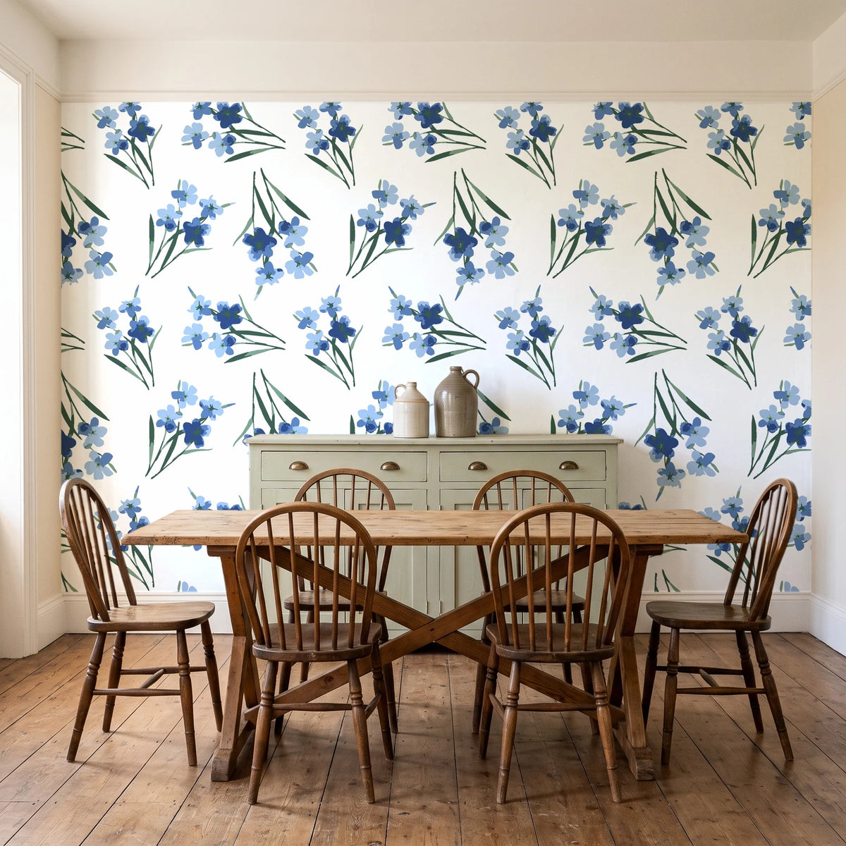 Sky Memory Midnight watercolor floral wallpaper in a farmhouse dining room with a sage sideboard and rustic trestle table