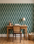 Smoke Ancestry Forest geometric wallpaper behind a vintage writing desk in a cozy craft-room home office