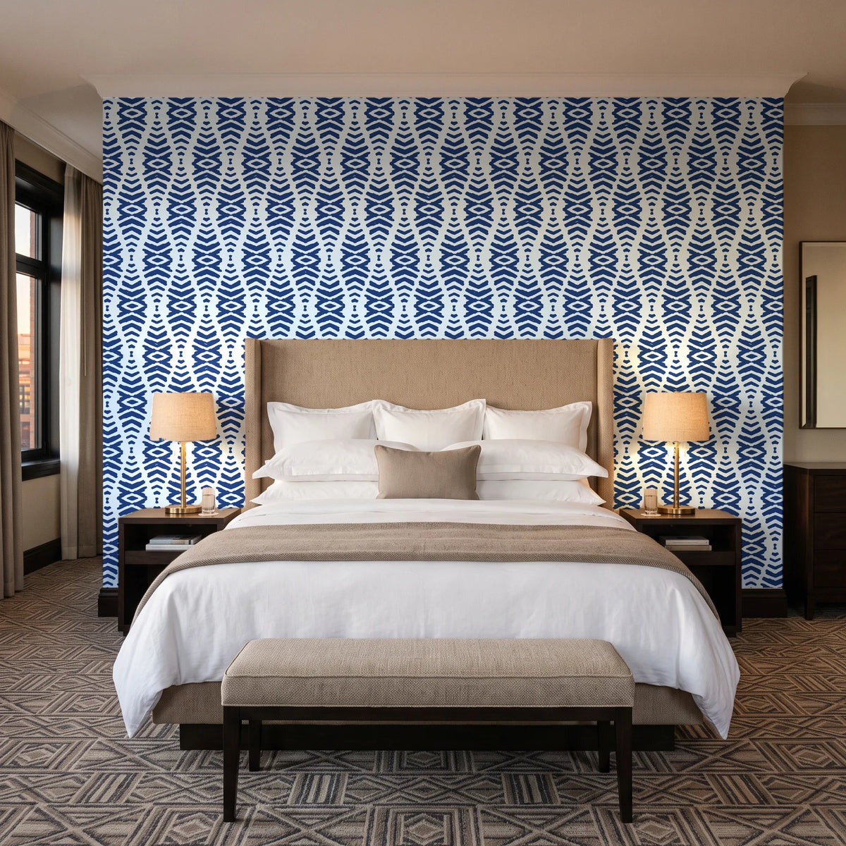 Smoke Ancestry Indigo geometric wallpaper behind the headboard of a king bed in a contemporary hotel guest room