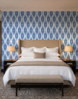 Smoke Ancestry Indigo geometric wallpaper behind the headboard of a king bed in a contemporary hotel guest room